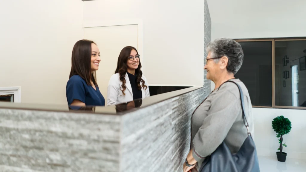 dental patient talking with reception team at globe dental practice